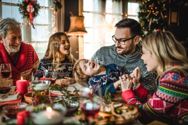 istock Happy extended family having fun during a meal on New Year. 1489059537