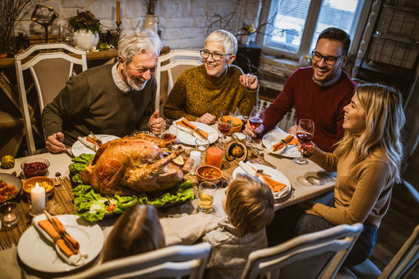 istock Happy extended family talking during Thanksgiving meal at dining table. 1489059625