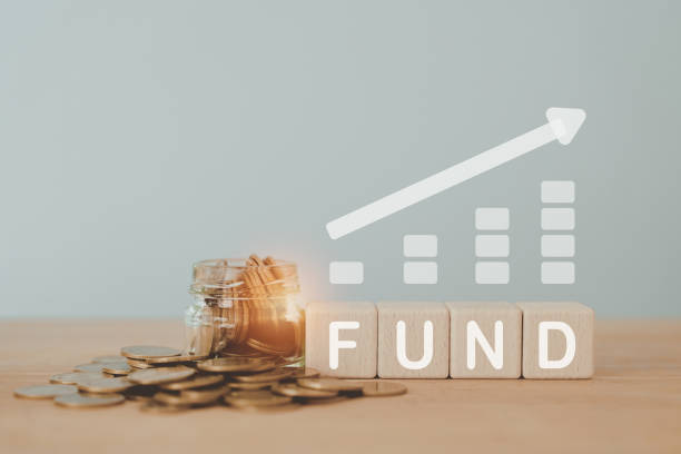 istock FUND text on wooden cube block and coins in jar with increasing graph for saving, provident, retirement, banking, business, finance concept 1489061980