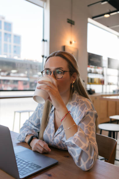 istock Young woman drinking coffee in cafeteria 1489062038