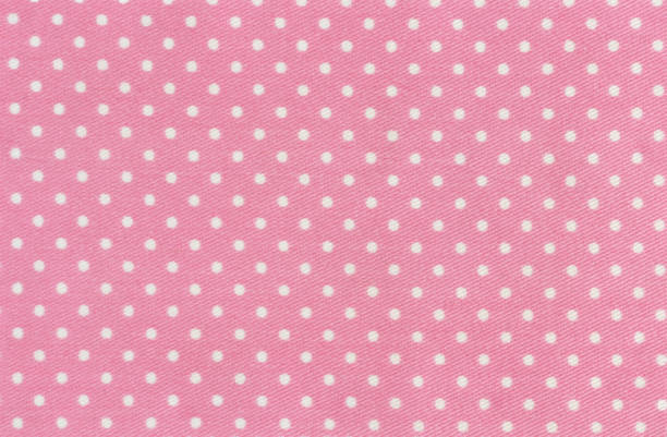 Pink and white polka dots baby textile background, Studio shot of high quality fabric sample. Taken with a 42 megapixel full format camera and prime lens