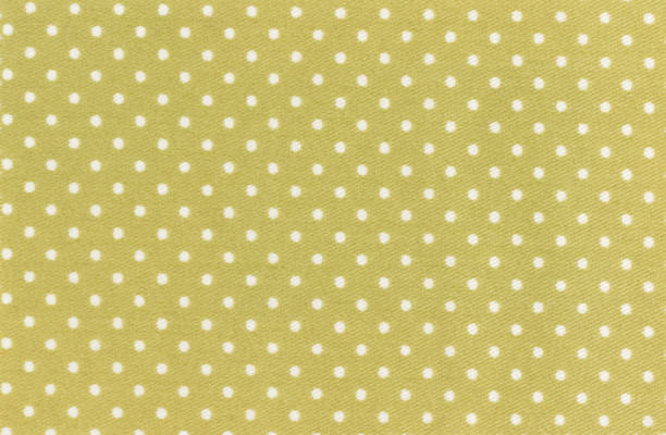 Golden dots scattered across a deep brown background for a seamless pattern design