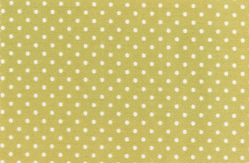 Polka dot background fabric in black and white.  Large and small dots mixed.