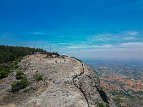 Nandi Hills, or Nandidurg, is a hill fortress in the south Indian state of Karnataka. Tipu Sultan Fort, a summer retreat of the namesake 18th-century ruler, features stone carvings and wall paintings. Prisoners are said to have been thrown to their death from Tipu’s Drop, now known for its panoramic views. Local Hindu temples include the hilltop Yoga Nandeeshwara Temple, guarded by a huge statue of a bull (nandi).