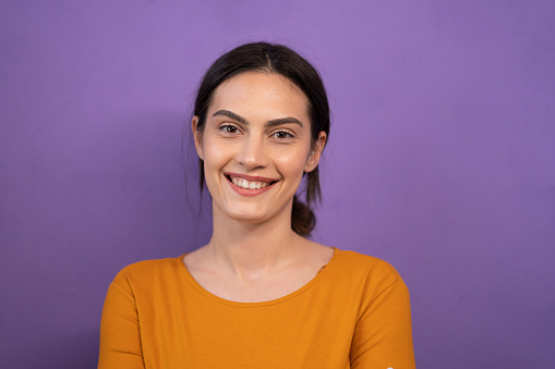 Portrait of young women in front of purple background