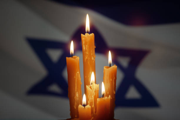 istock Six burning candles on Israel flag background. 1489067734