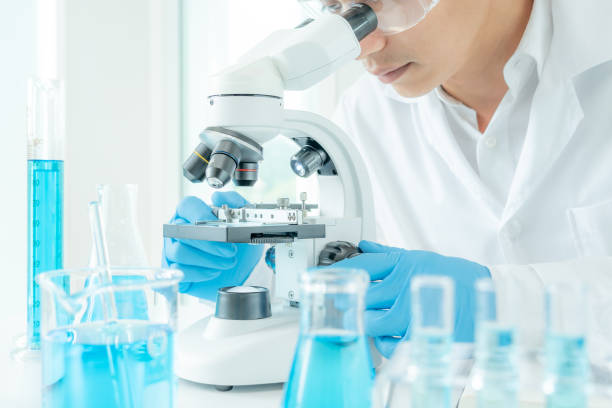 istock Scientist analyze biochemical samples in advanced scientific laboratory. Medical professional use microscope look microbiological developmental of viral. Biotechnology research in science lab. 1489068436