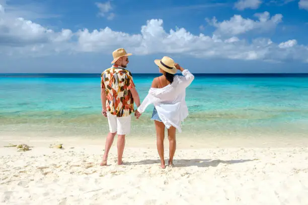 Playa Porto Marie Beach in Curacao, a tropical beach on the Caribbean Island of Curacao. A couple of men and women on the beach in Curacao