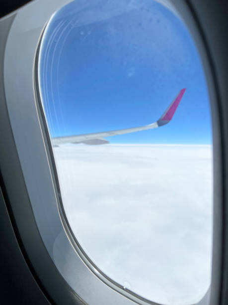 istock View from the airplane window. Beautiful cloudscape with blue sky. Wonderful panorama above white clouds as seen through window of an plane. Traveling by air concept 1489071756