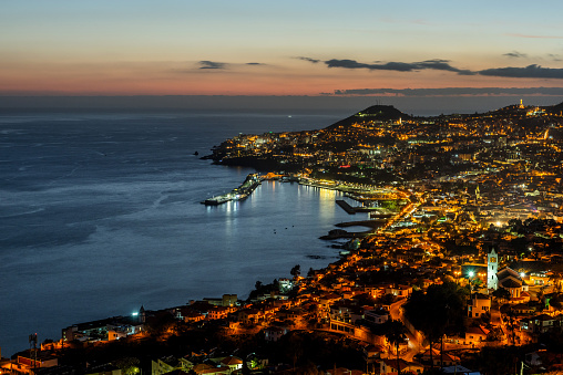 Aerial cityscape of Illuminated Funchal, Madeira at twilight.