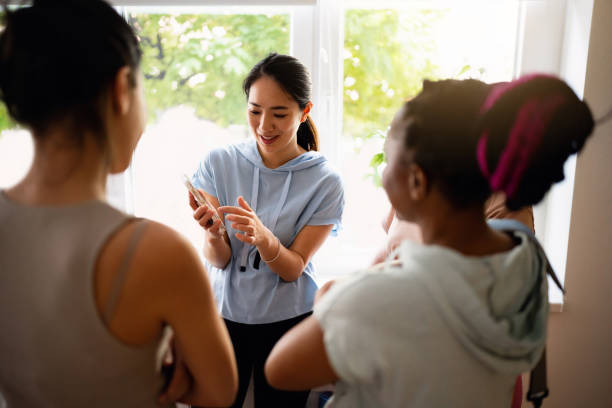 Carefree multiracial women hang out at the yoga studio, before yoga class
