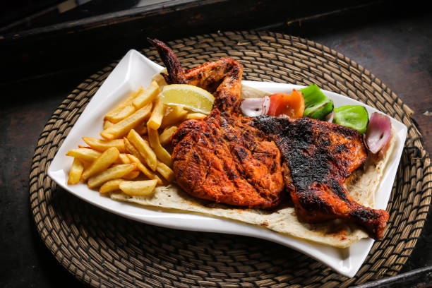 full chicken grill with fries and salad served in dish isolated on red mat top view on table arabic food - grilled chicken fotos imagens e fotografias de stock