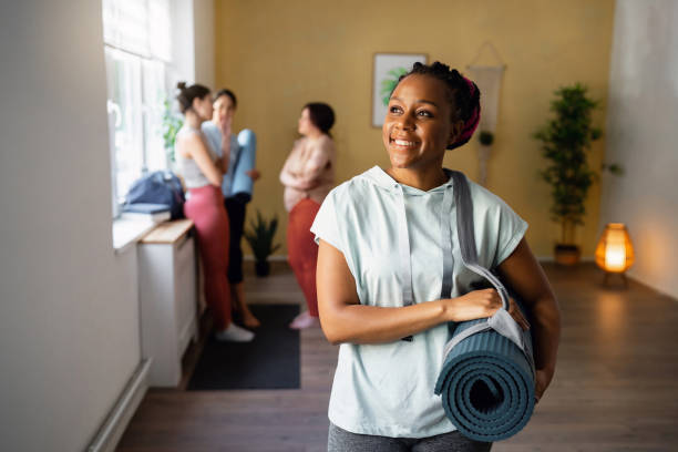 Portrait of woman Black ethnicity at the yoga studio Portrait of a woman Black ethnicity, at the yoga studio, before or after yoga class yoga instructor stock pictures, royalty-free photos & images