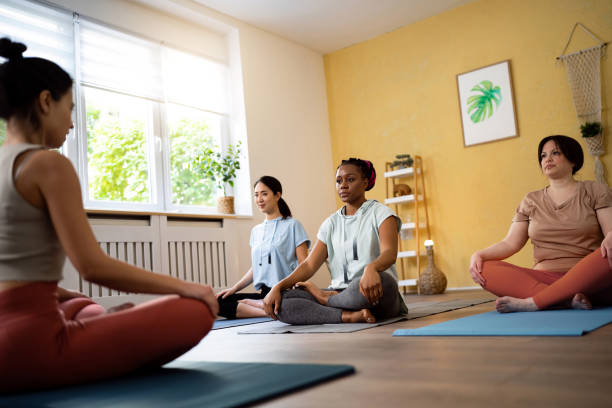 istock Yoga instructor leading an group yoga class 1489079524