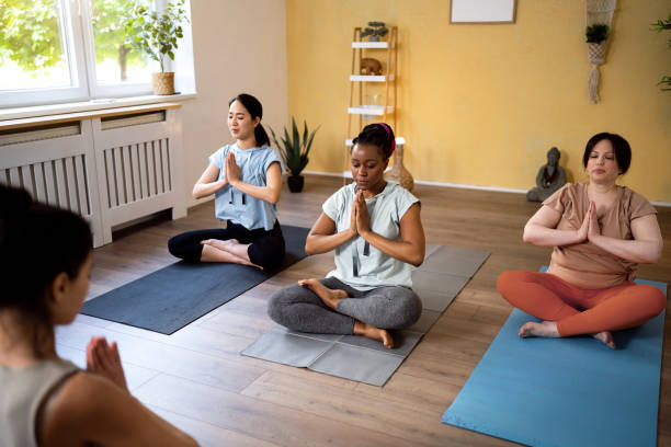 istock Yoga instructor leading an group yoga class 1489079818