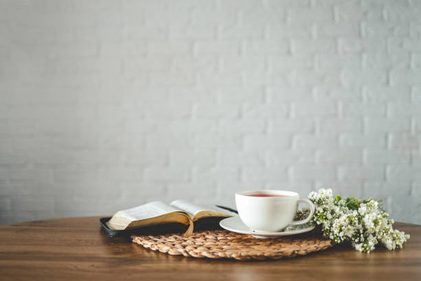 istock Open bible, flowers and a cup of tea, space for text 1489080764