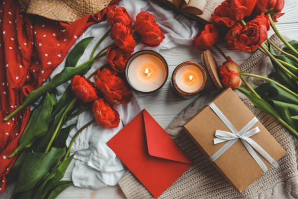 istock Festive composition top view flat lay. Gift box, flowers, envelope, candles 1489082733