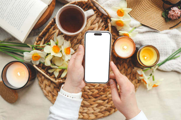 istock Phone with isolated screen and spring composition of candles and flowers 1489083919
