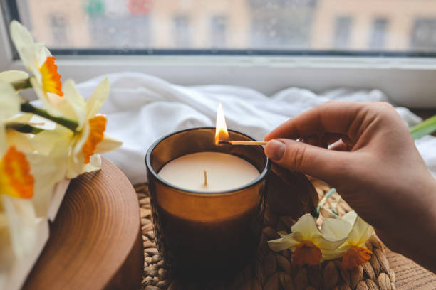 istock Match in hand lights a candle, atmospheric photo 1489084389
