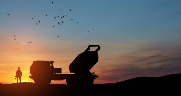 istock Artillery rocket system are aimed to the sky and soldier at sunset. Multiple launch rocket system. 1489087090