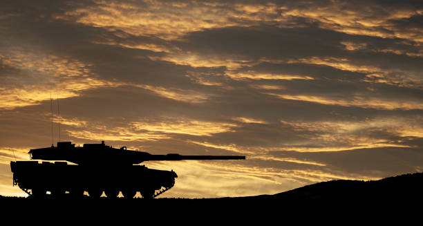 istock Silhouette of army tank at sunset sky background. 1489087113