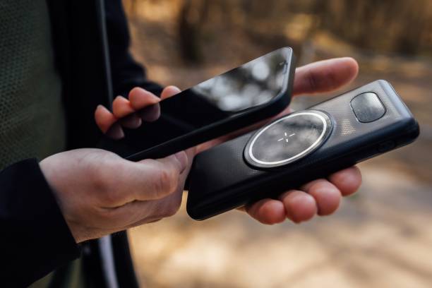 istock Adult male using two different electronic devices in an outdoor setting 1489088655