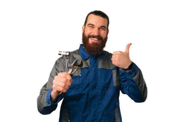 istock Wide smiling ready to work handyman is holding some tools and a thumb up. 1489088873