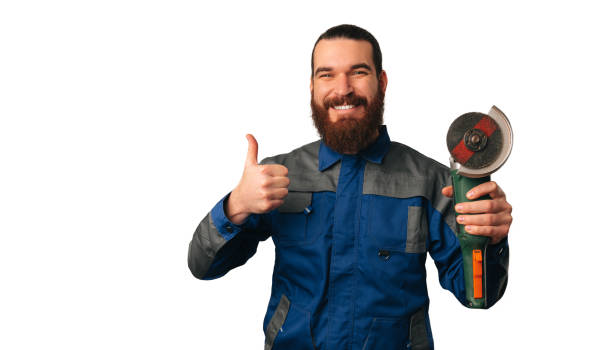 istock Handsome smiling handy man is holding an angle grinder and a thumb up. 1489088876