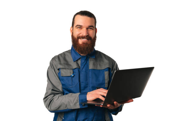 istock Wide smiling bearded man wearing engineer uniform is holding a laptop. 1489088888