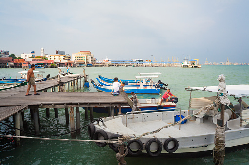 Georgetown, Penang, Malaysia - September 03, 2014: Pier on stilts with boats in Chew Jetty sea floating village in historical Georgetown, Penang, Malaysia