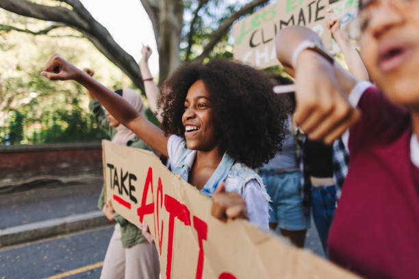istock Cheerful young people standing up against climate change 1489090845