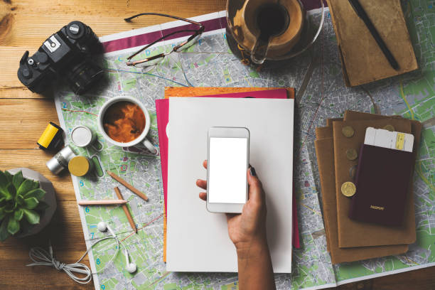 istock Travel concept flat lay, hand holding blank screen phone mockup 1489090870