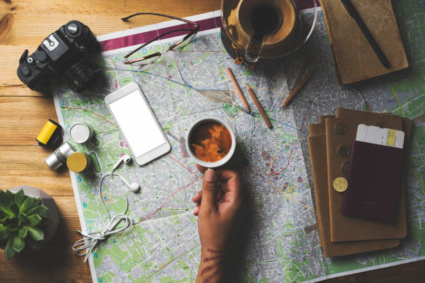 istock Travel concept flat lay with white screen phone mockup, hand holding coffee 1489090991