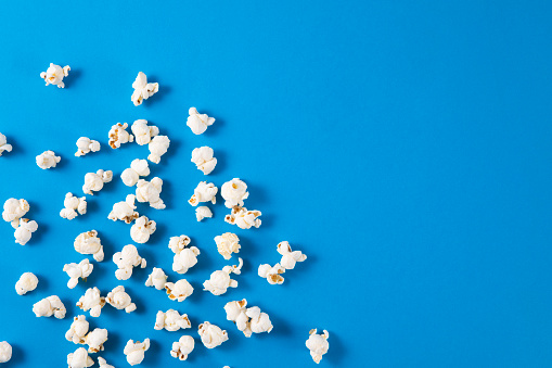Fresh popcorn with copy space on blue background