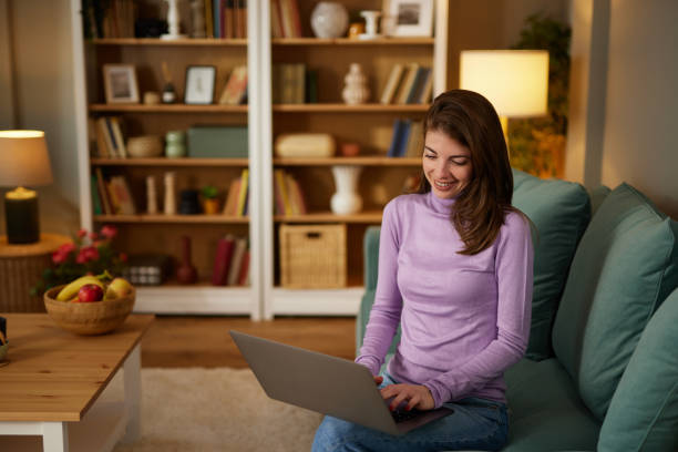 istock Young smiling woman working remotely from home on laptop 1489093173