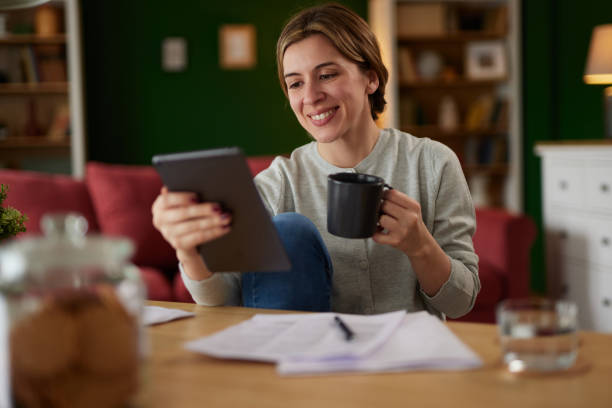 istock Women using digital tablet to check her finances at home office 1489093437