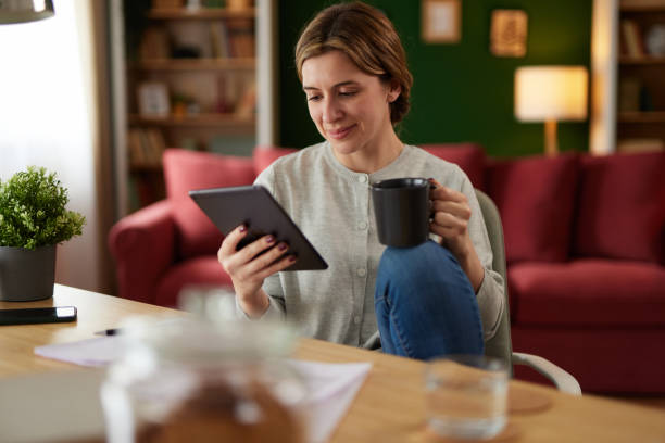 istock Women using digital tablet to check her finances at home office 1489093589