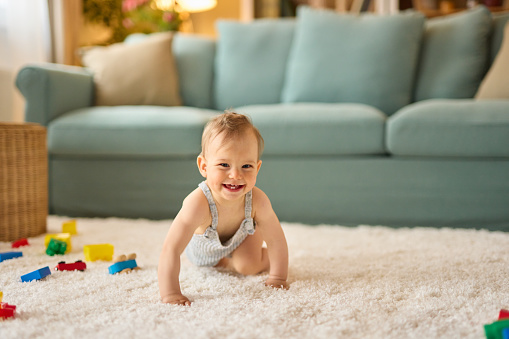 Portrait of a cute crawling baby boy at home