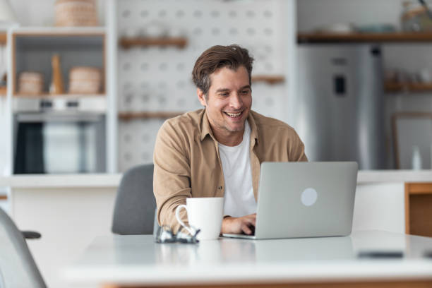 istock A man sitting at the dining table, typing on his laptop and drinking morning coffee. 1489095211