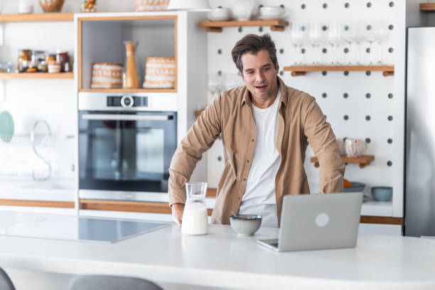 istock A middle-aged male freelancer having a laptop video call and having breakfast in his kitchen. 1489095399
