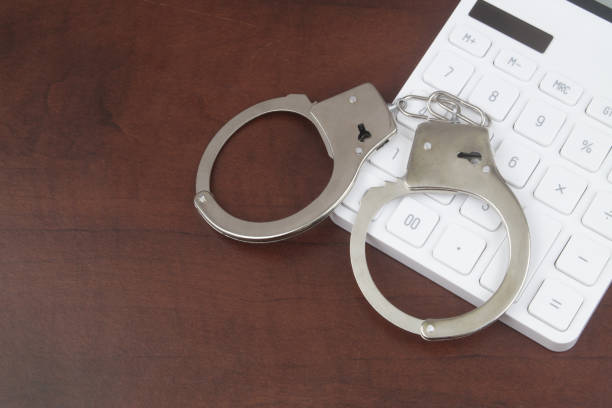 istock Handcuffs and calculator with room for text 1489096483