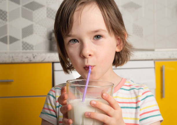istock Child drinking fresh tasty milk from a straw 1489096950