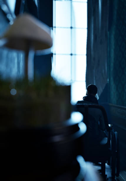 istock Dark room with man in wheelchair by window. 3D render. 1489100945