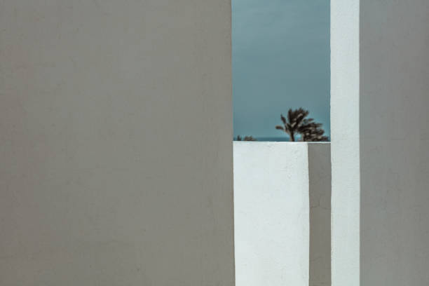 Closeup photo of a white walls of a building in sunny day. Minimalism in architecture design of a house. Summer vacation background.