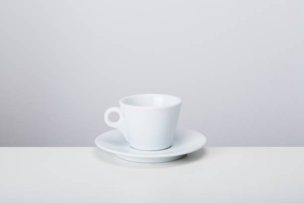 istock White porcelain mic espresso coffee cup with saucer on white background, soft shadow 1489103949