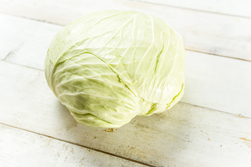 Big flat cabbage on a white board
