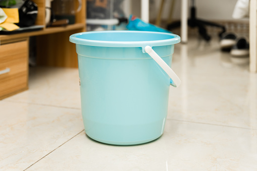 A bucket placed in the living room