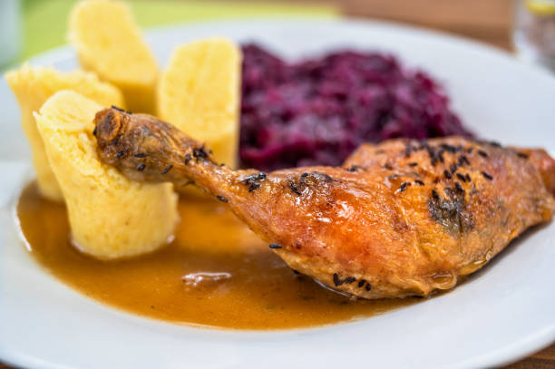 Roast chicken thigh, stewed red cabbage and sliced potato dumpling.