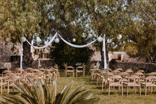 istock Wedding altar with chairs under green trees outdoors 1489108289