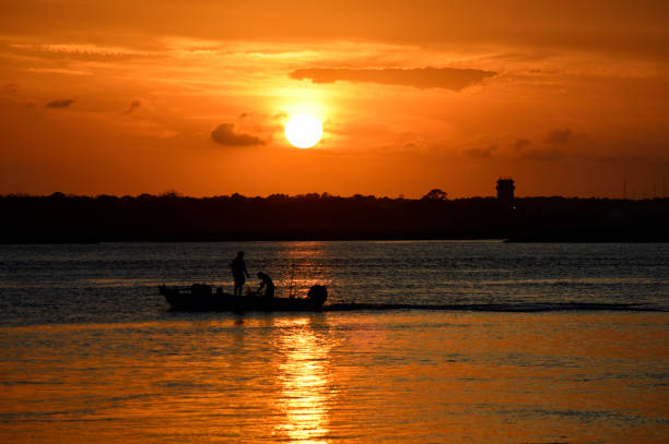 istock Boat cruising along the river at sunset 1489109189